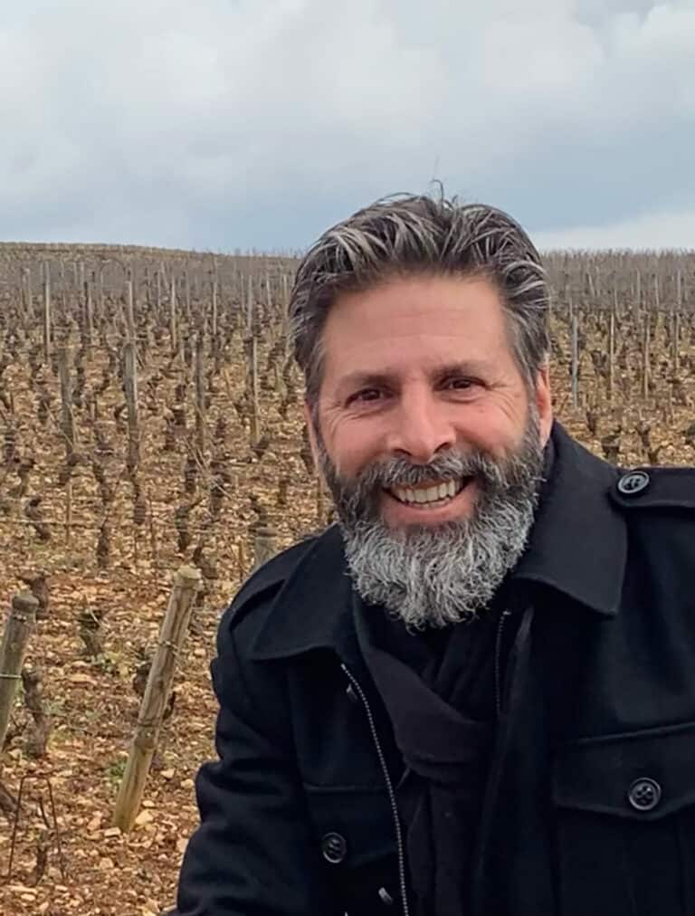Vineyard man enjoying wine tasting outdoors in the vineyard.